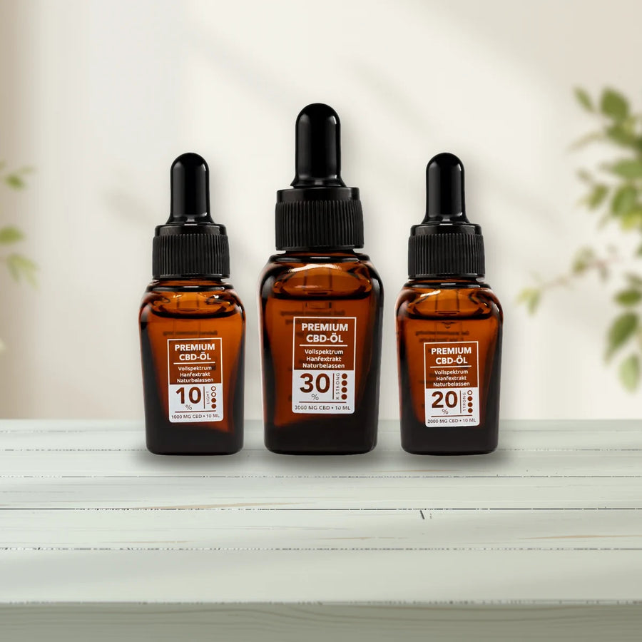 CBD Öle: CBD-Öl-Flaschen auf salbeigrünem Holz